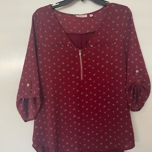 Burgundy mixed materials geo print top in size large, button detail on sleeve